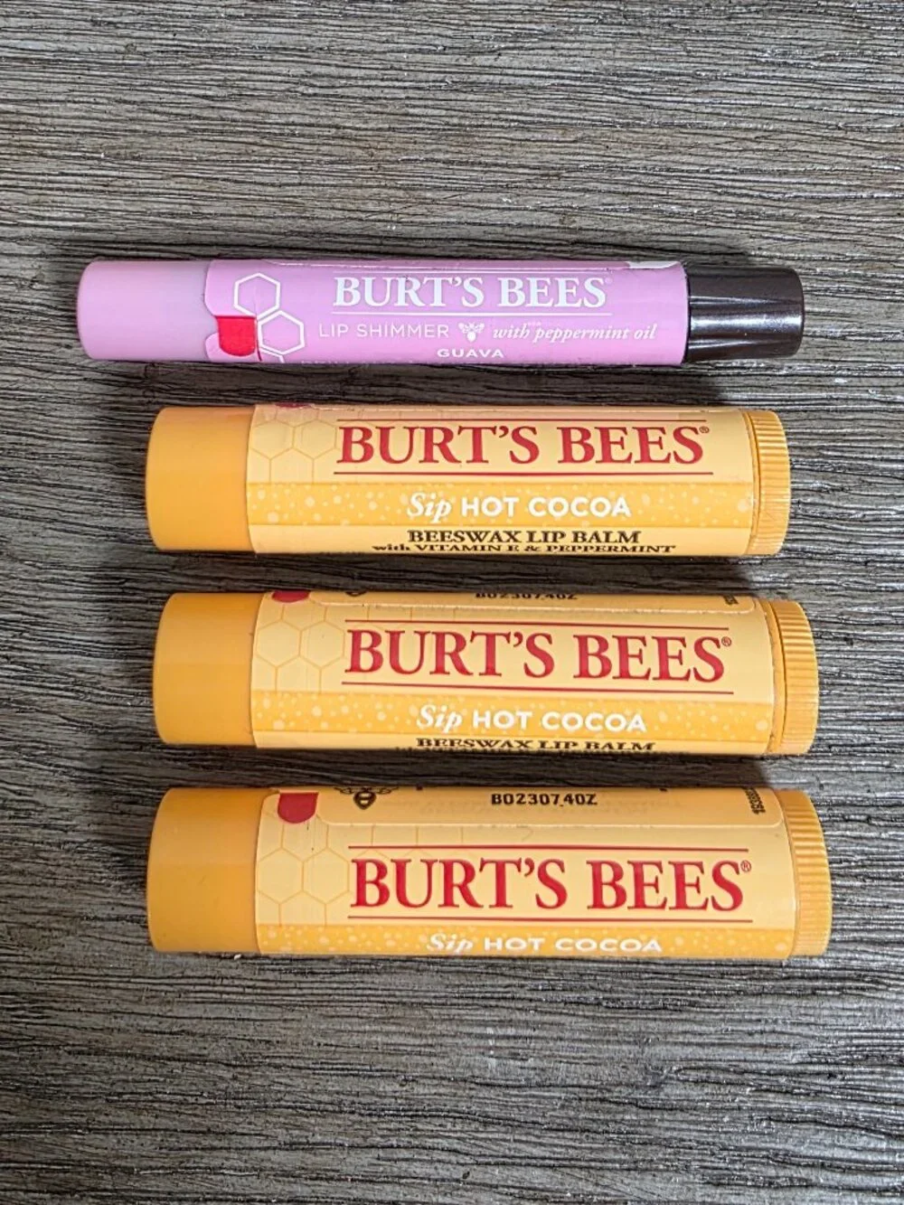 Three (3) Burt's Bees Hot Cocoa Lip Balm and One (1) Lip Shimmer Guava SEALED
